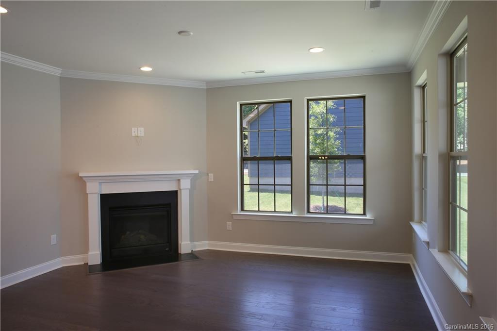 132 Helton Lane, Unit 38 Fort Mill, SC 29708 - Photo 10 of 23 an empty room with wooden floor fireplace and windows