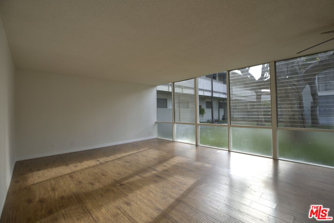 an empty room with wooden floor and door