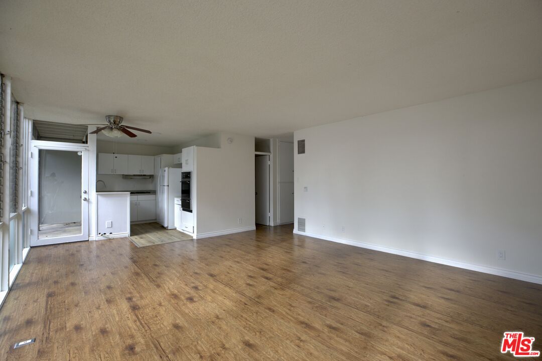 11131 Rose Avenue, Unit 13 Los Angeles, CA 90034 - Photo 2 of 17 a view of empty room with wooden floor