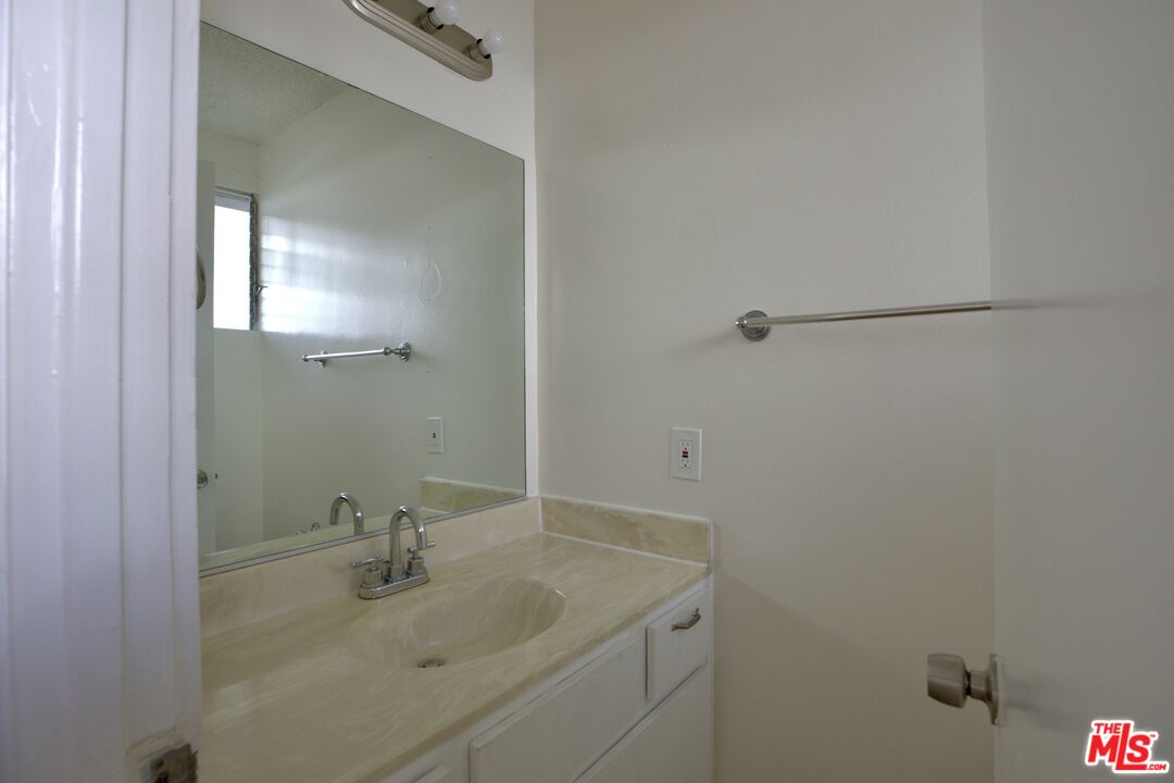 11131 Rose Avenue, Unit 13 Los Angeles, CA 90034 - Photo 8 of 17 a bathroom with a sink and vanity