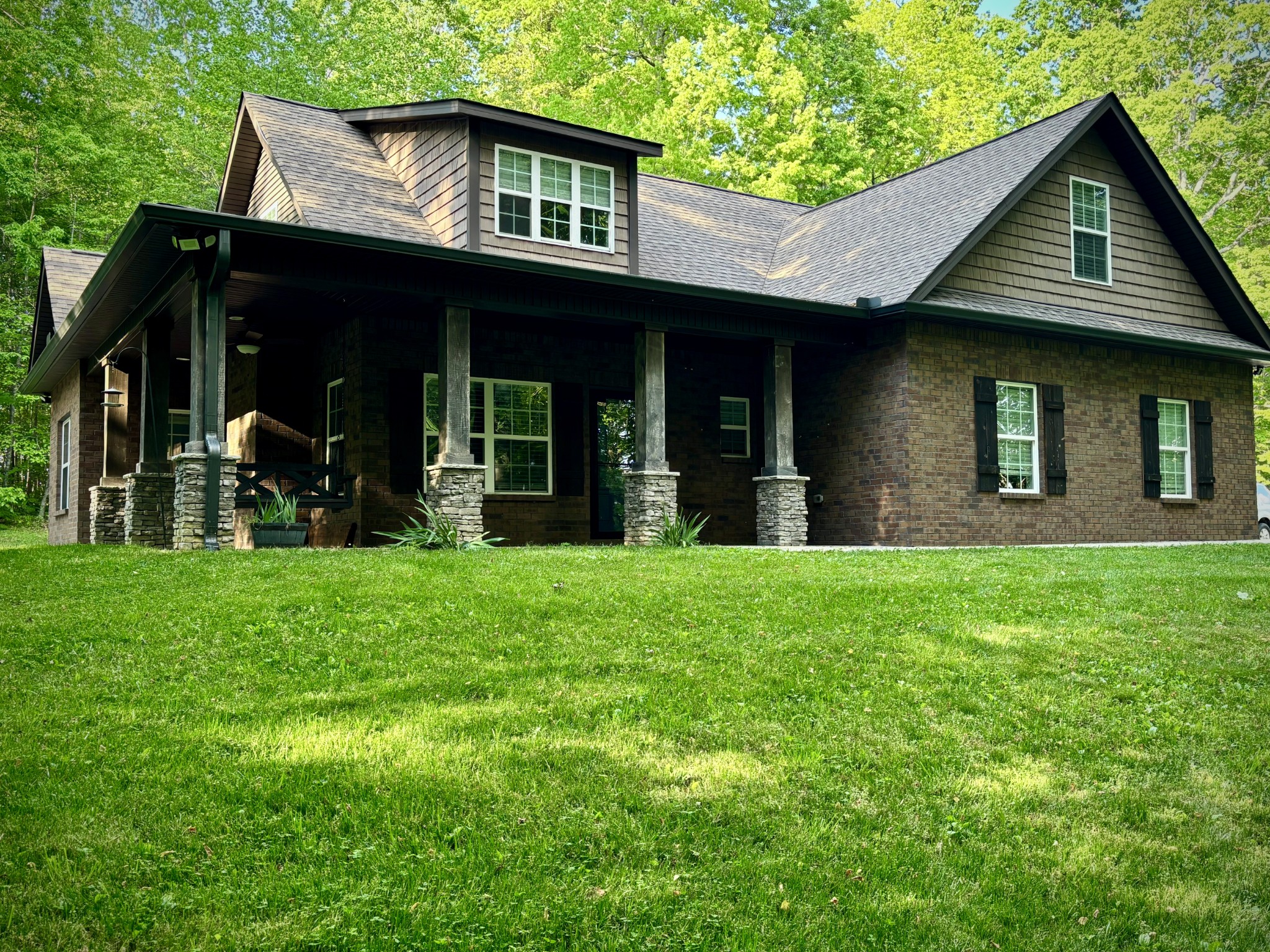 a view of a house with yard and front view of a house