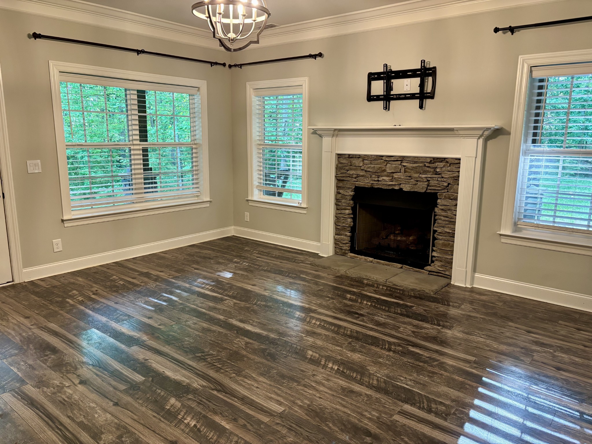 65 Sheltontown Road Manchester, TN 37355 - Photo 7 of 17 a view of an empty room with wooden floor fireplace and a window