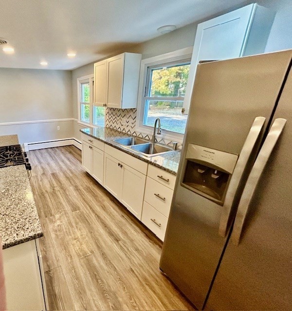 15 Garcia Street Springfield, MA 01129 - Photo 4 of 11 a kitchen with stainless steel appliances a refrigerator sink and wooden floor