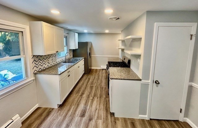 15 Garcia Street Springfield, MA 01129 - Photo 5 of 11 a kitchen with kitchen island a counter top space wooden floor and stainless steel appliances