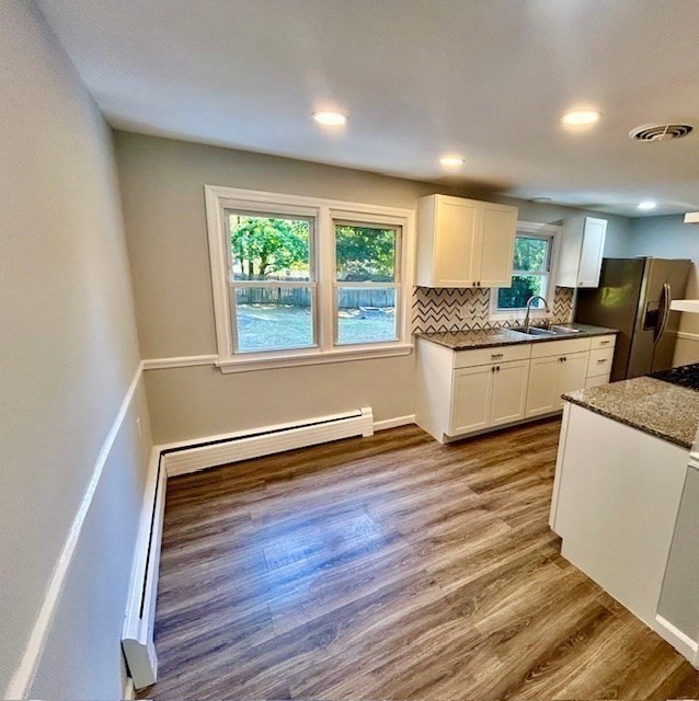 15 Garcia Street Springfield, MA 01129 - Photo 6 of 11 a kitchen with granite countertop a stove and a wooden floors
