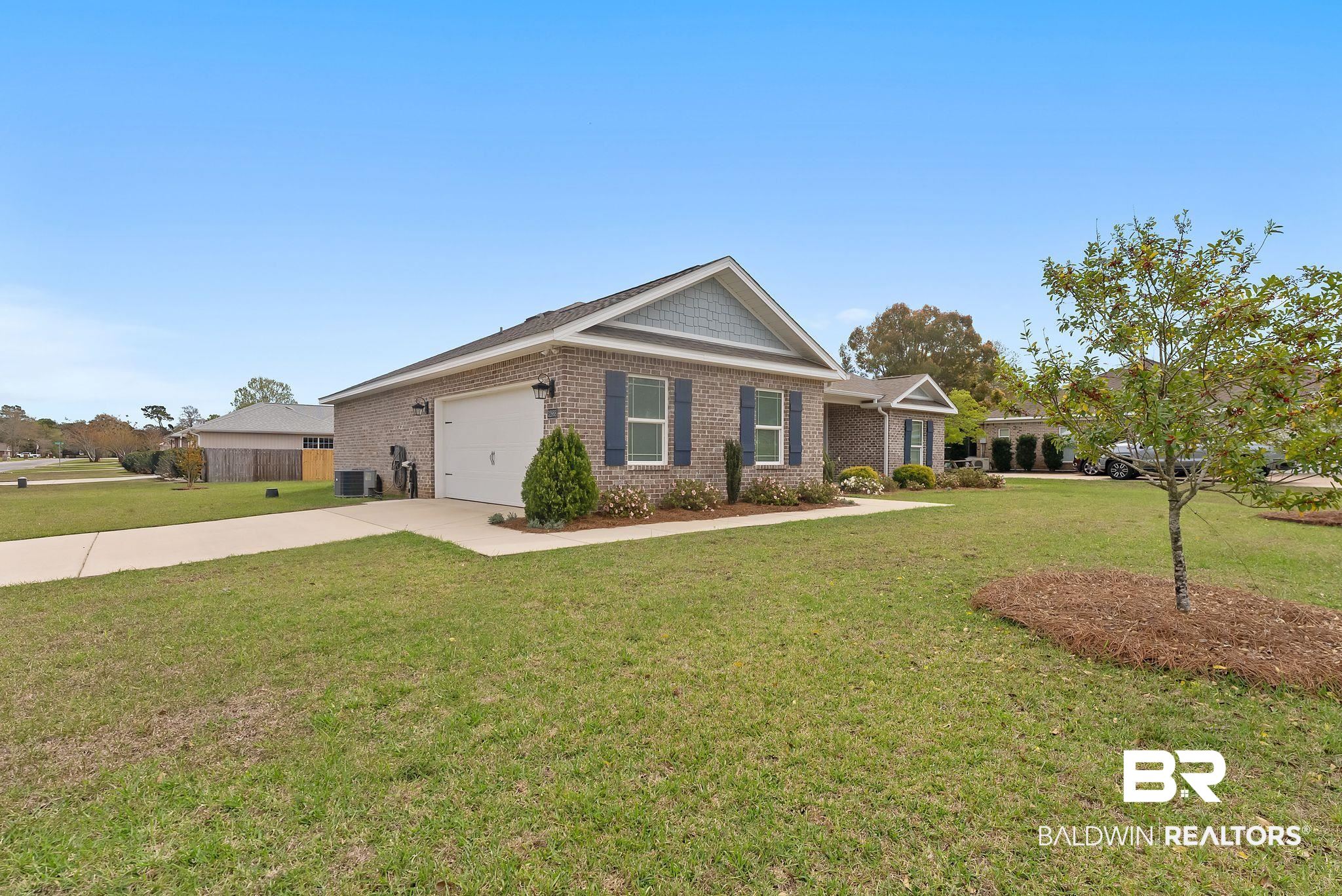 32868 Arbor Ridge Circle Lillian, AL 36549 - Photo 2 of 35 Ranch-style house with brick siding, a front lawn, driveway, and a garage