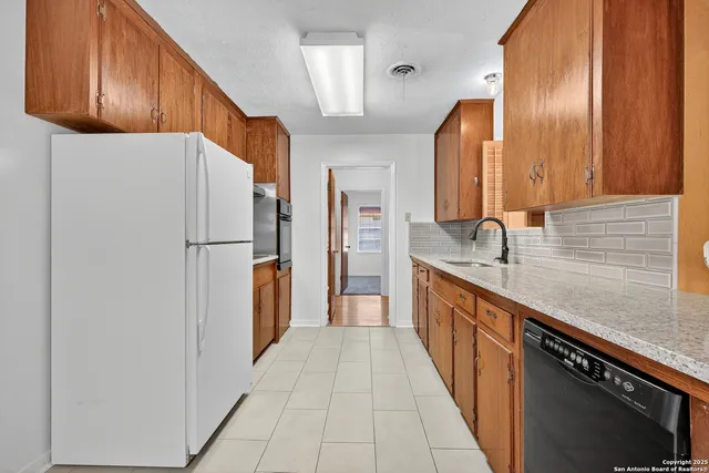 a kitchen with stainless steel appliances a refrigerator and a sink