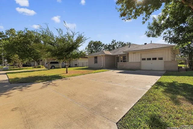 a view of swimming pool with palm trees