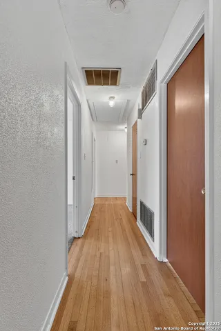 a view of hallway with wooden floor