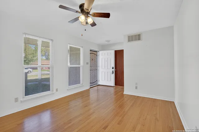 wooden floor in an empty room with a window