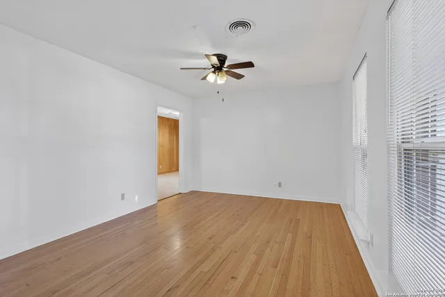 wooden floor in an empty room with a window