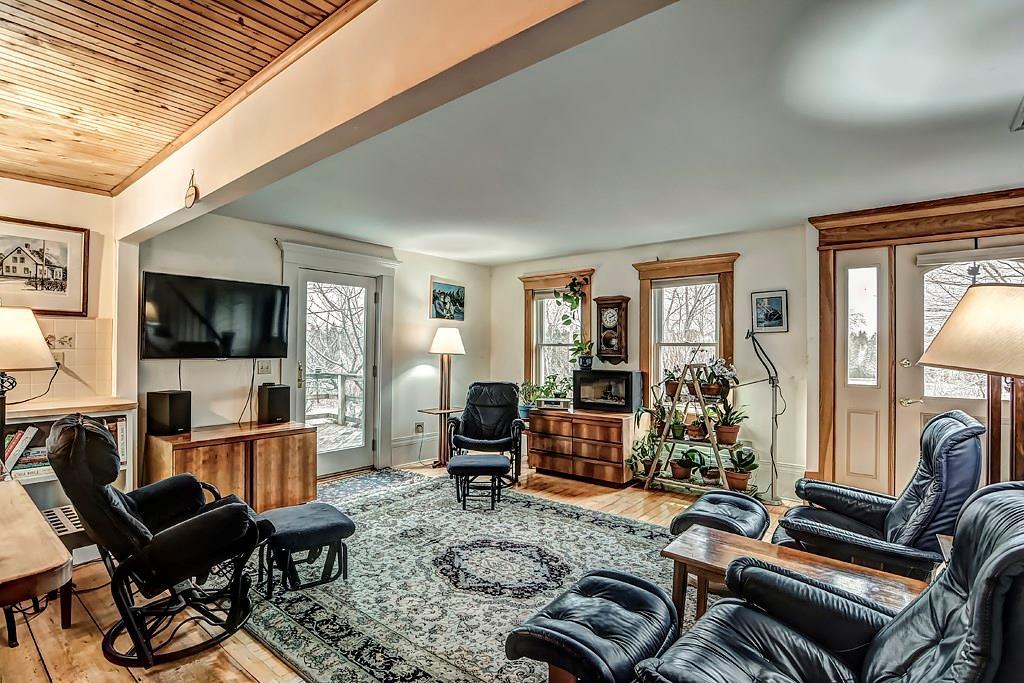 110 Naskeag Point Road Brooklin, ME 04616 - Photo 8 of 34 Living room has two doors to the...