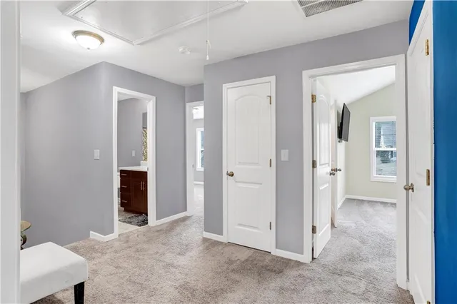 a living room with furniture and a air conditioner vent