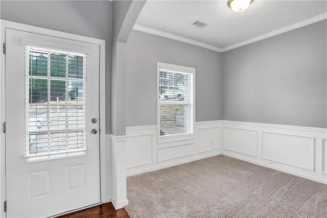 a dining room with wooden floor a chandelier a wooden table and chairs