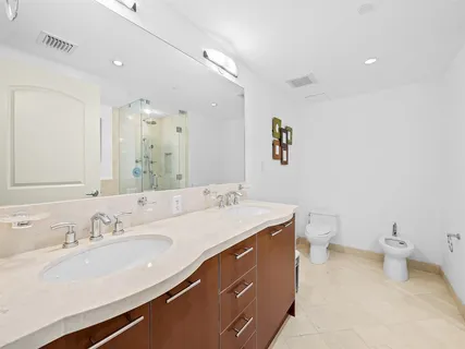 a bathroom with a sink double vanity and a toilet