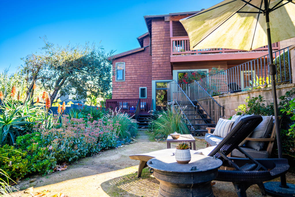 a view of a house with backyard sitting area and garden