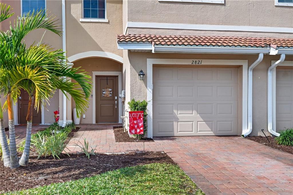 2821 Citrus Street Naples, FL 34120 - Photo 12 of 32 Property entrance featuring a garage, stucco siding, and driveway