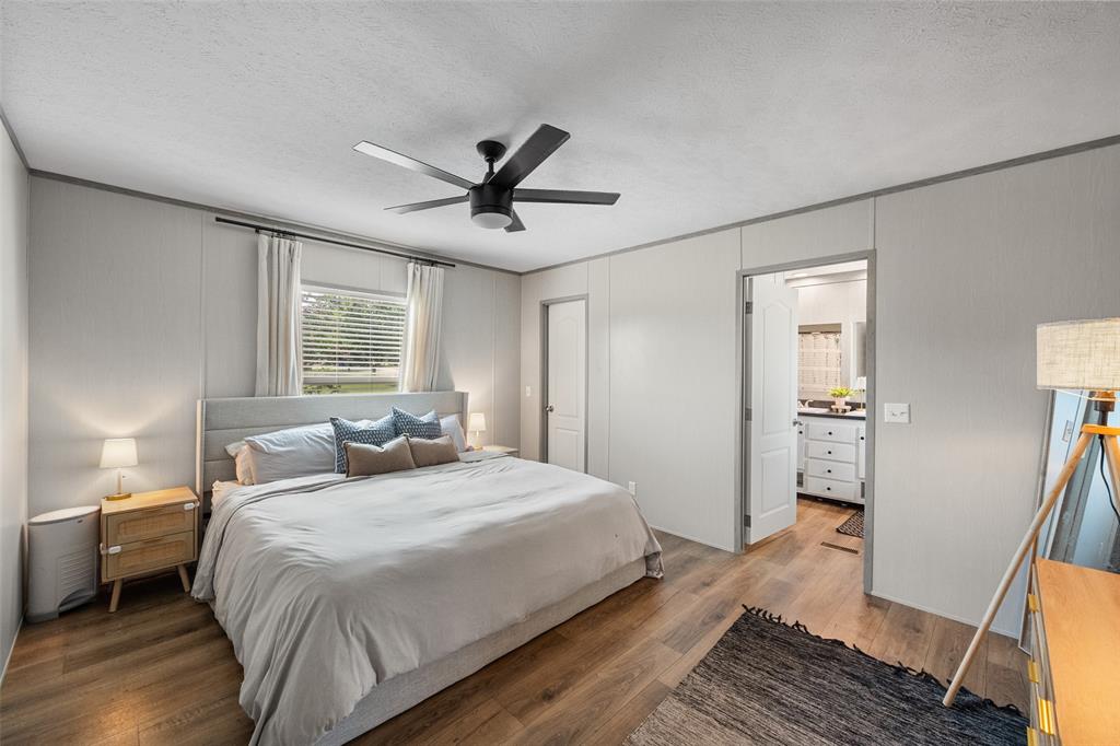 421 Garitty Street Frost, TX 76641 - Photo 13 of 25 a bedroom with a bed and wooden floor