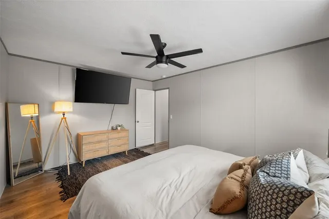 a bedroom with a bed and a flat screen tv