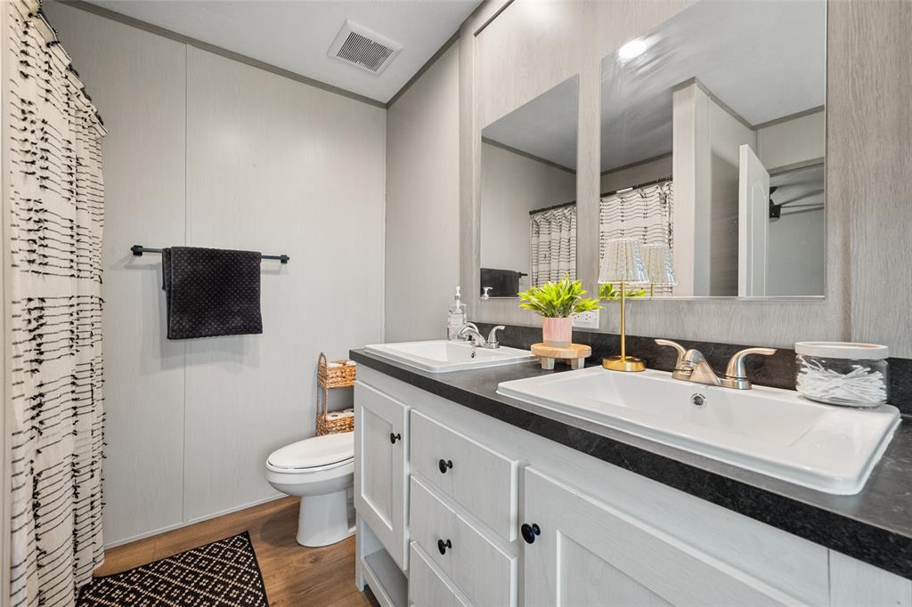 421 Garitty Street Frost, TX 76641 - Photo 15 of 25 a bathroom with a sink a toilet and mirror
