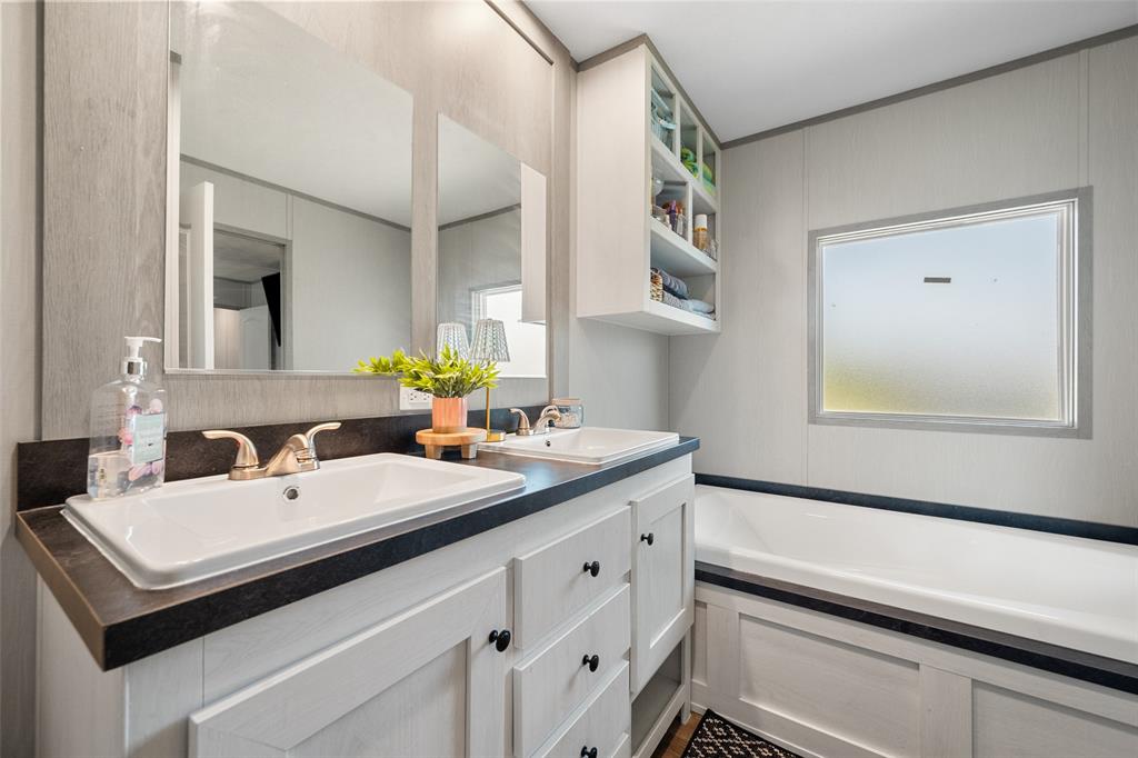 421 Garitty Street Frost, TX 76641 - Photo 16 of 25 a bathroom with a sink and a mirror