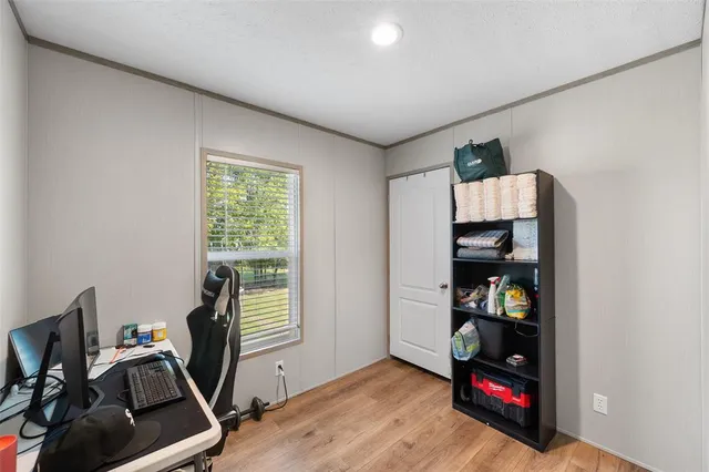 a view of a room with workspace and a window