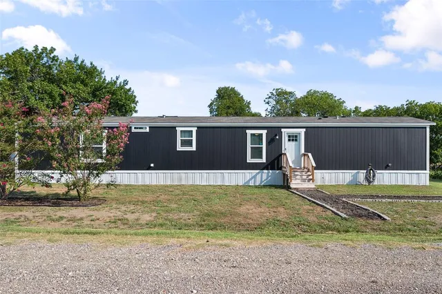 a view of a house with pool and a yard