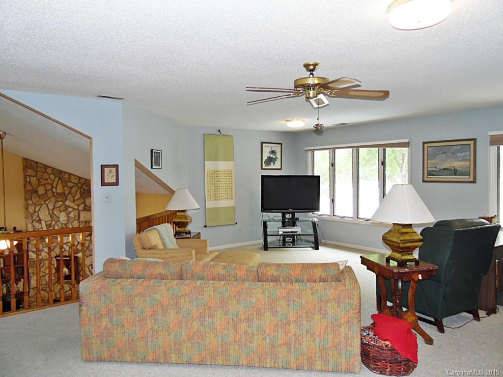 988 Cove Point Lane Tega Cay, SC 29708 - Photo 11 of 22 a living room with furniture and a flat screen tv