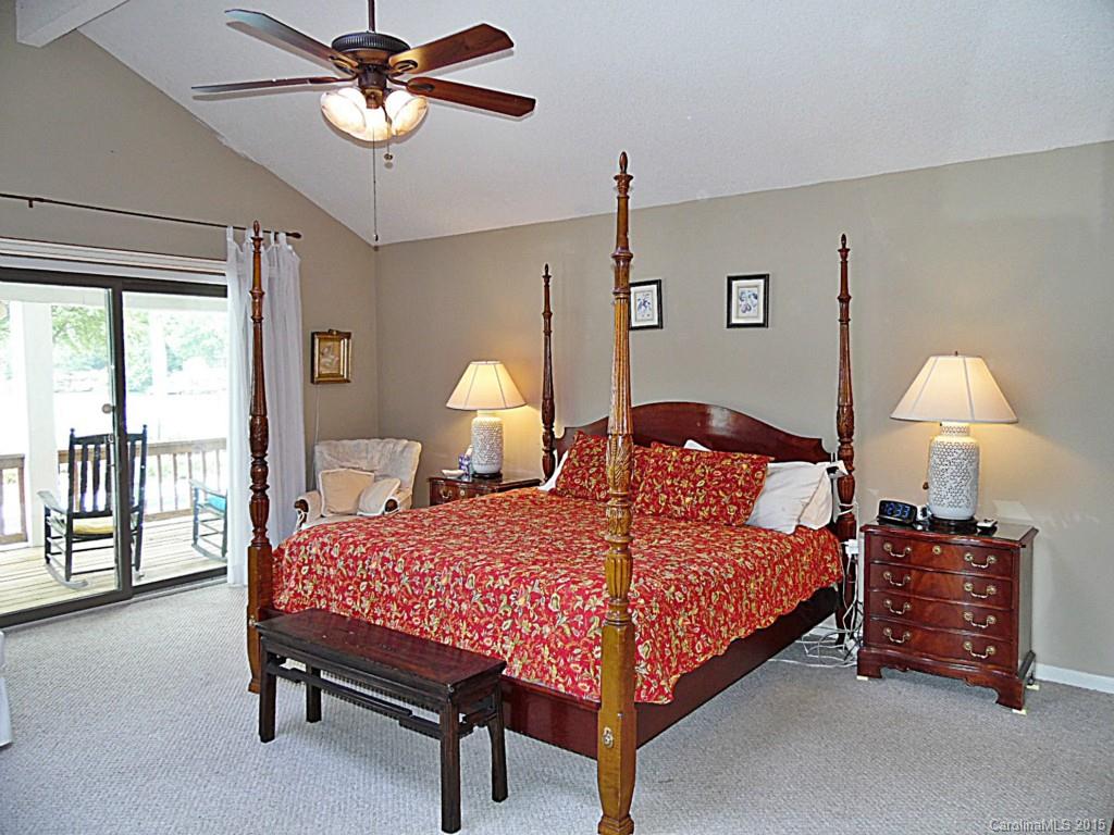 988 Cove Point Lane Tega Cay, SC 29708 - Photo 13 of 22 a bedroom with a bed and a chandelier