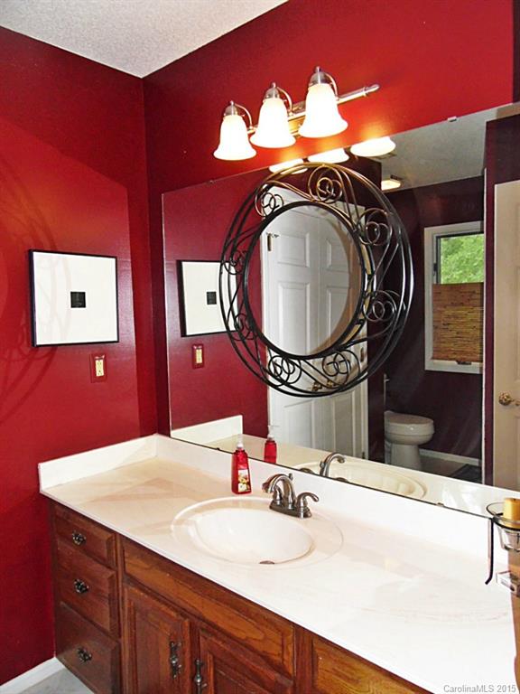 988 Cove Point Lane Tega Cay, SC 29708 - Photo 14 of 22 a bathroom with a sink double vanity and a mirror
