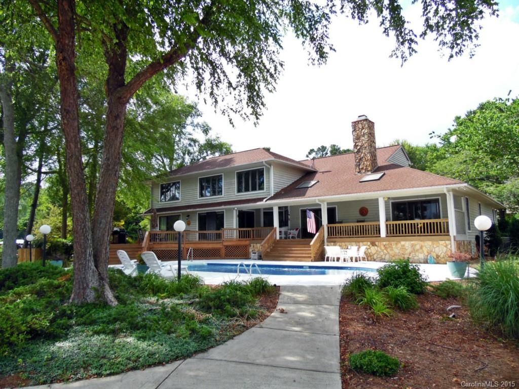 988 Cove Point Lane Tega Cay, SC 29708 - Photo 16 of 22 a front view of a house with trees and plants
