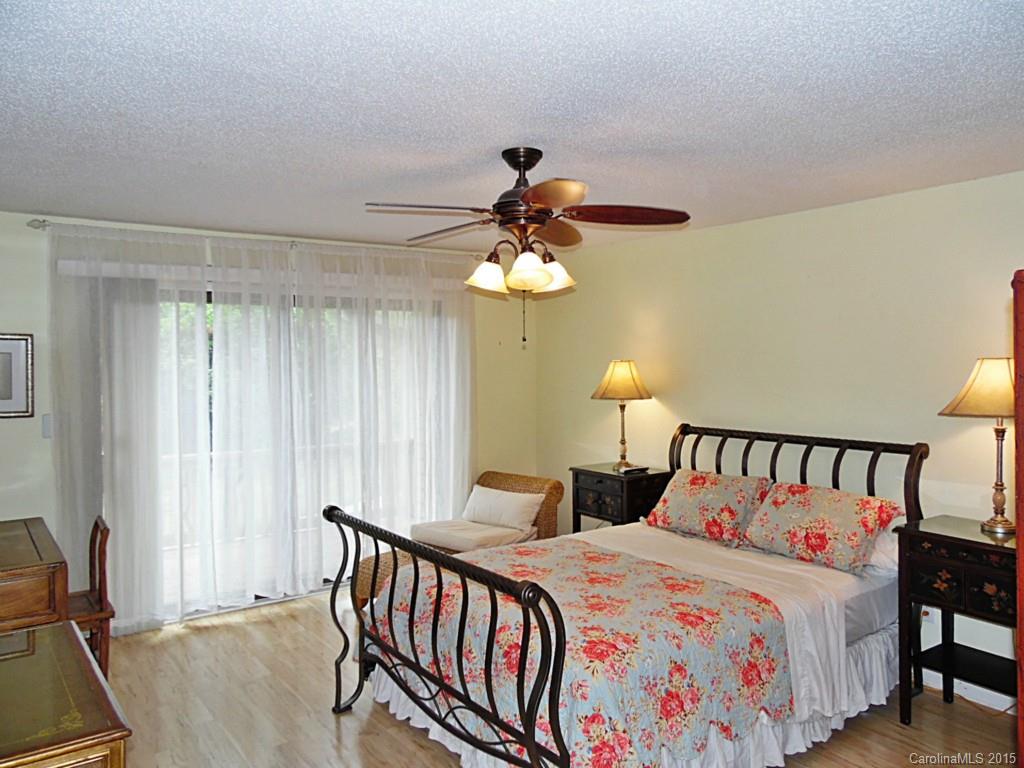 988 Cove Point Lane Tega Cay, SC 29708 - Photo 4 of 22 a bedroom with a bed and a chandelier