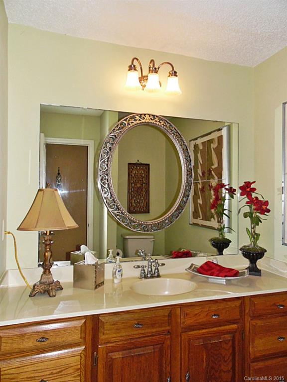 988 Cove Point Lane Tega Cay, SC 29708 - Photo 7 of 22 a bathroom with a granite countertop sink and a mirror