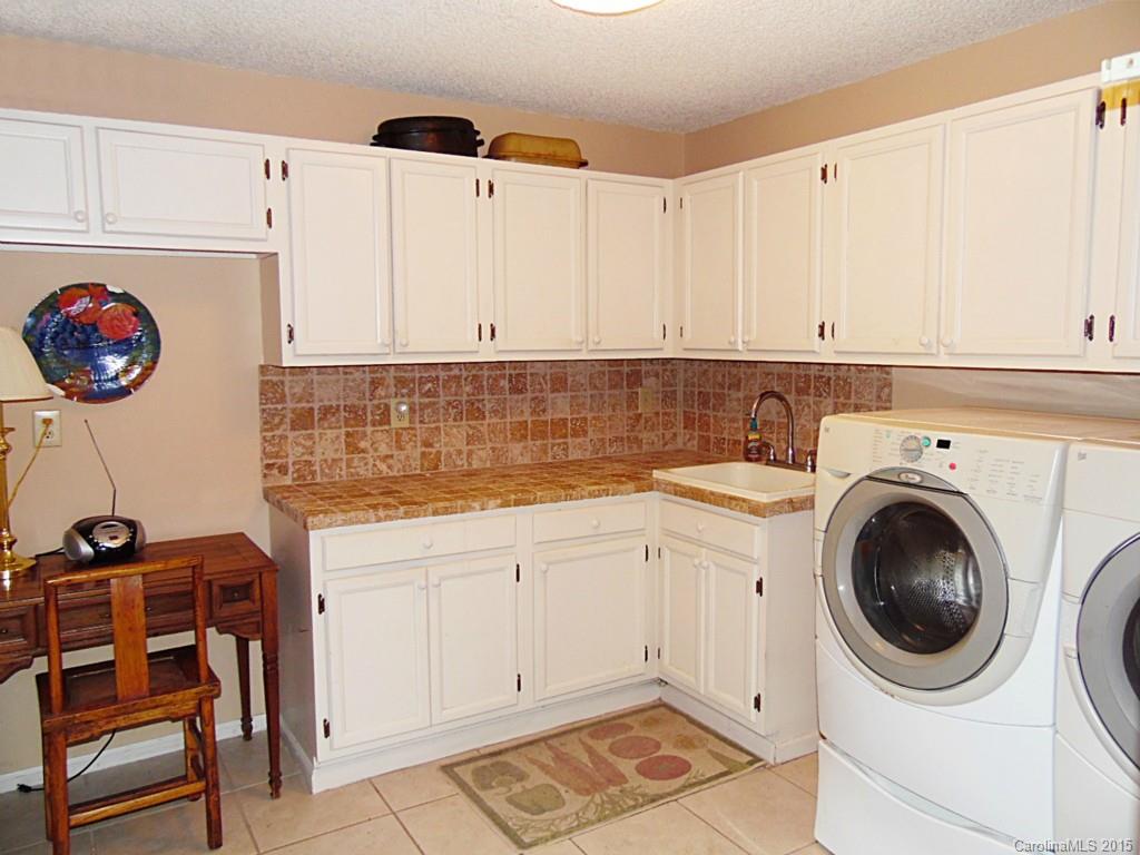 988 Cove Point Lane Tega Cay, SC 29708 - Photo 10 of 22 a view of a kitchen with fridge and workspace