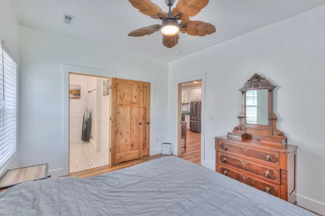 a bedroom with a dresser and a chandelier