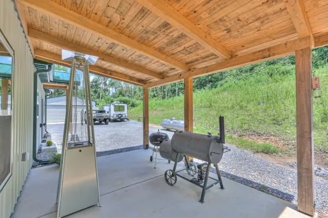 a patio with yard and outdoor seating