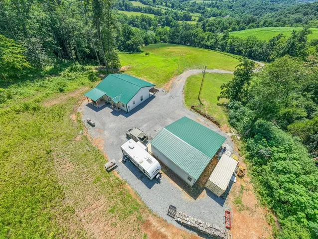 an aerial view of a house with a garden and swimming pool