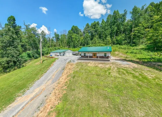 a view of a swimming pool with an outdoor seating and a yard