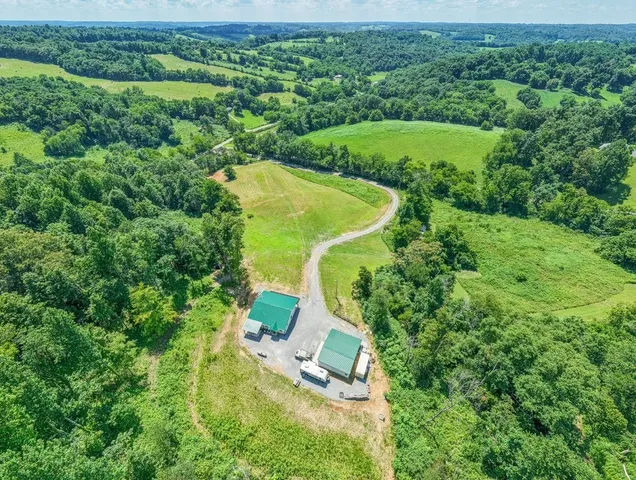 an aerial view of a house with a yard and lake view