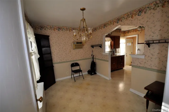 a view of a kitchen with furniture and stainless steel appliances