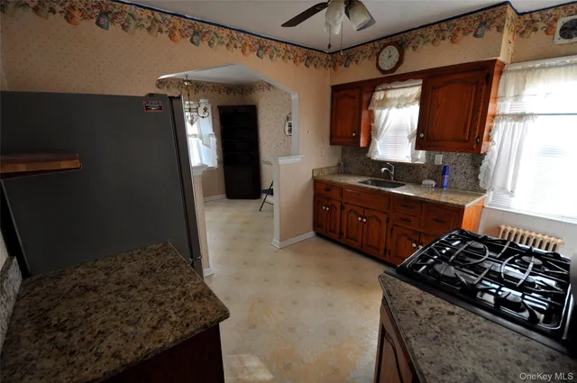 a kitchen with wooden cabinets and a stove top oven