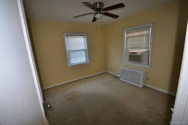 an empty room with a window and closet