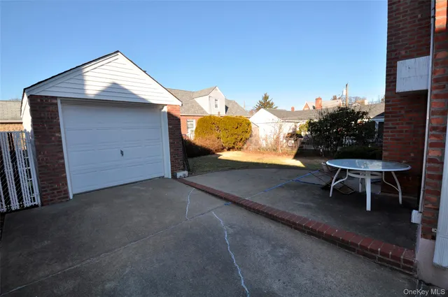 a view of a chairs and table in the back yard of a house