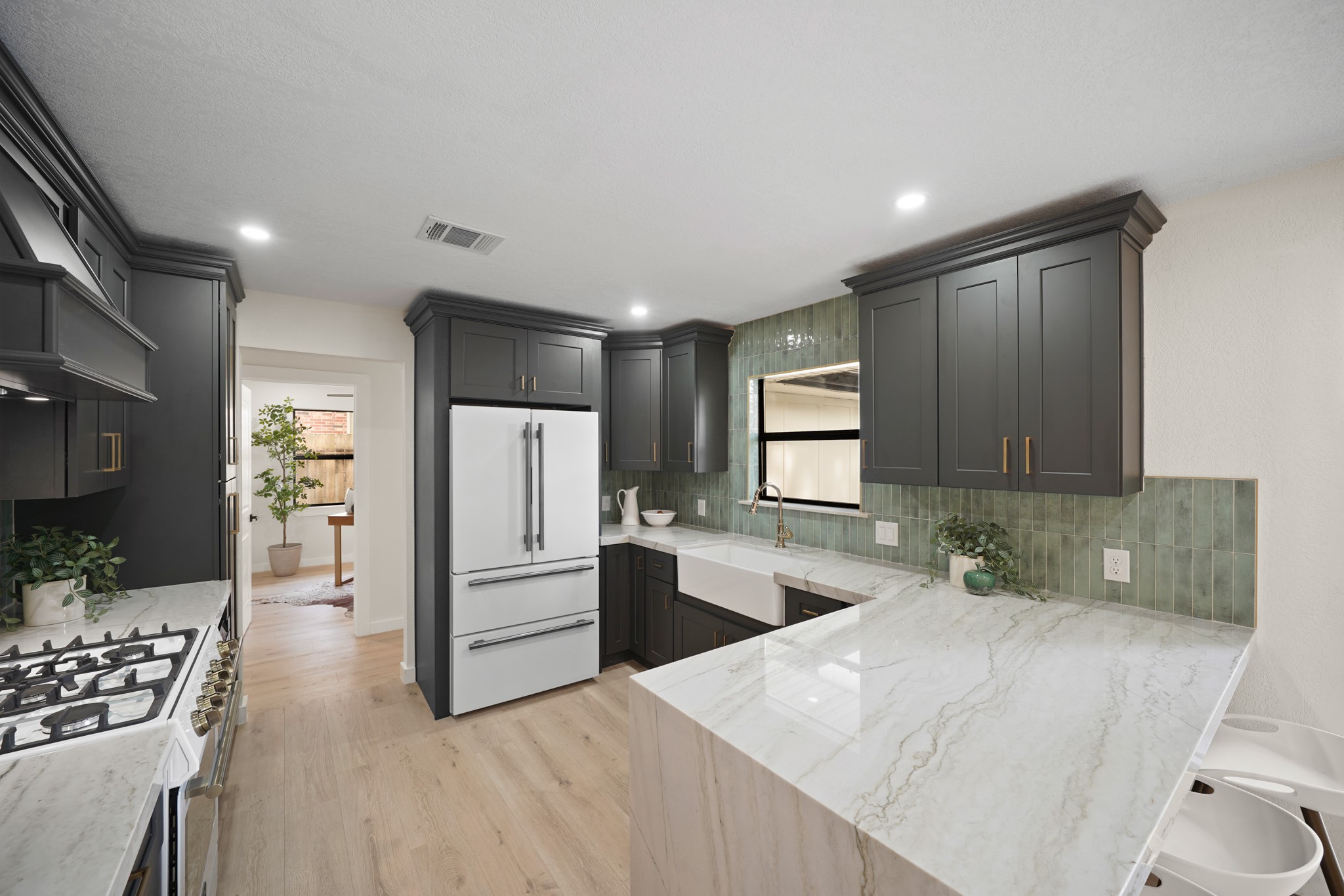 4813 Hummingbird Street Houston, TX 77035 - Photo 9 of 50 a kitchen with a refrigerator a stove top oven a sink and dishwasher