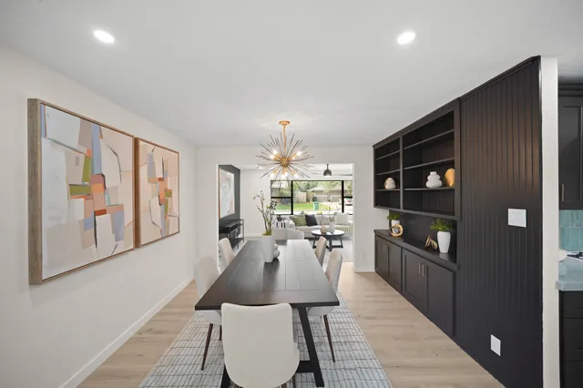 a dining room with furniture and a floor to ceiling window