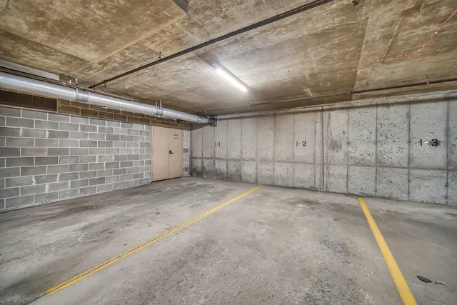 a view of parking garage with cars