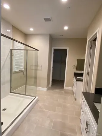 a bathroom with a tub sink and glass door