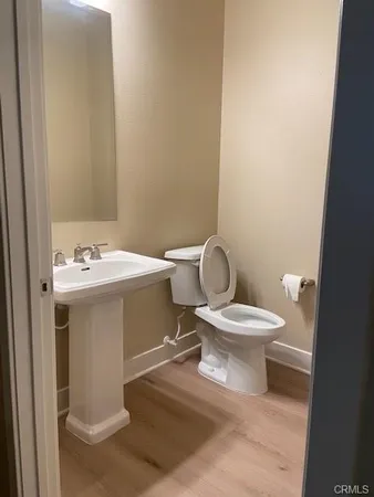 a white toilet sitting next to a bathroom sink