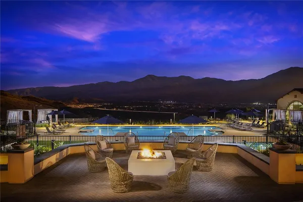 a view of a swimming pool with a table and chairs