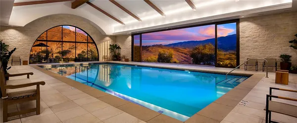 a front view of a house with swimming pool and a yard